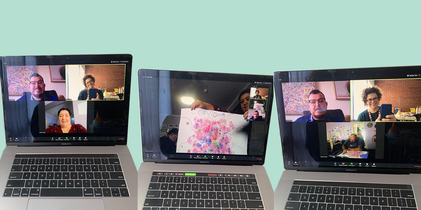 Three laptops with a Zoom call on the screens.