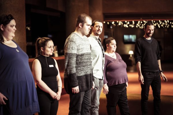 The Echo Collective ensemble is standing up in front of a crowd.