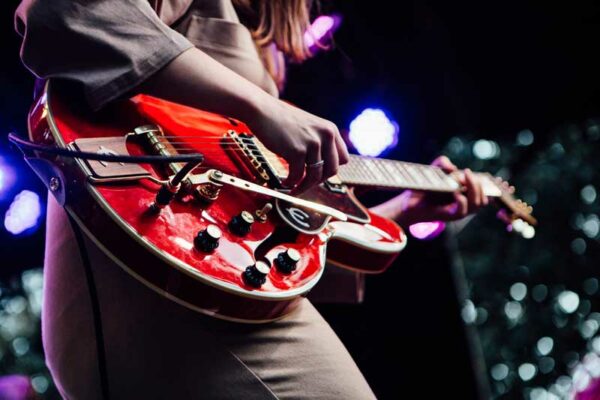 A person playing an electric guitar.