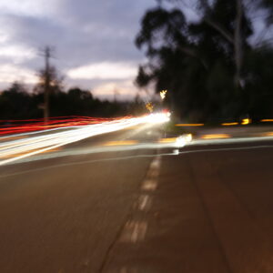 A photograph of a road taken at dawn or sunset.