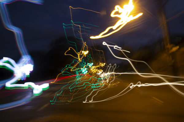 A photograph of a street lamp taken at night time.