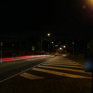 A photograph of a road taken at night time.