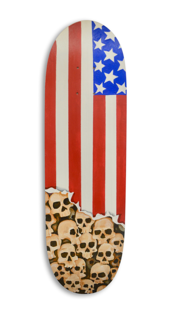 A skateboard with a portion of the USA flag painted on it and skulls under it.