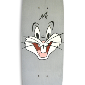 A skateboard with the face of Bugs Bunny painted on a grey background.