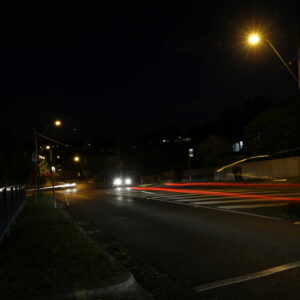 A photograph of a road taken at night time.