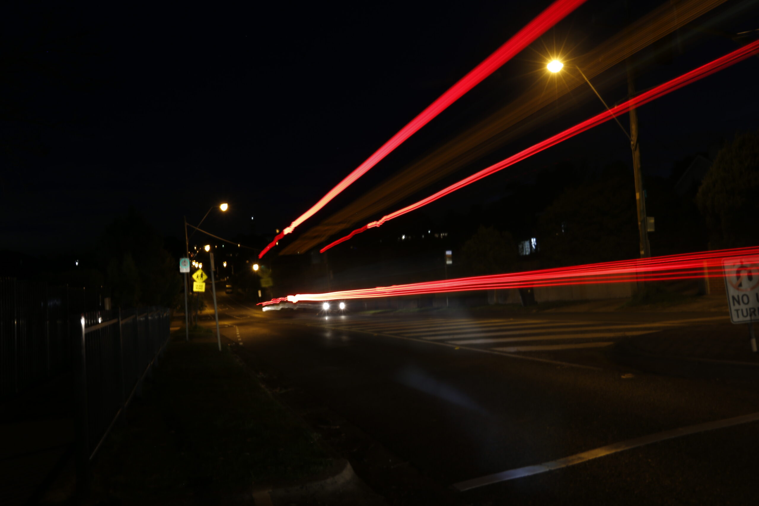 A photograph of a road taken at night time.