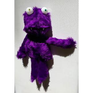 a furry purple monster with yellow and green eyes.