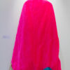 a mannequin's back displaying a long pink cape with blue and purple fabric at its base and wearing a royal crown made of paper.