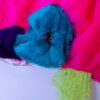 rich pink fabric with fluffly blue and purple fabric, and yellow tulle attached.