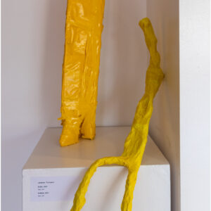two yellow figures made from bright tape on a plinth, one seated with long legs, one is standing with short stout legs