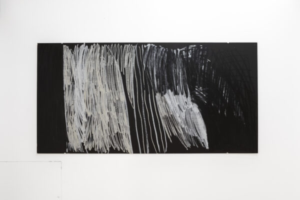 Black rectangular board with swathes of chalk-white vertical brushstrokes in blocks of varying intensity.