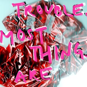 Trouble. Most things are in pink text overlaid on a photo of a crumpled red piece of paper.