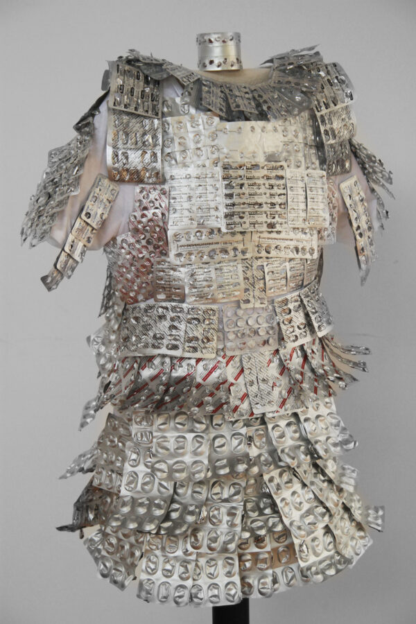 A suit of armour on a mannequin made from pill packets.