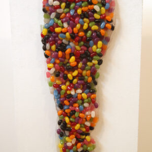 A dripping mass of jelly beans drips down a white background.