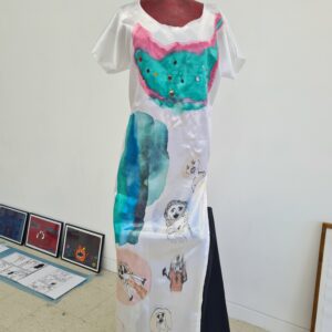 A white satin dress covered in paintings of famous women.