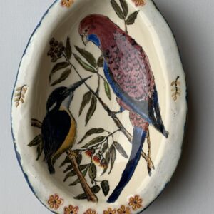 An egg shaped ceramic bowl featuring different species of birds.