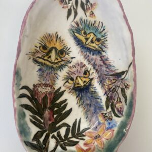 A ceramic bowl featuring three emus and native plants.