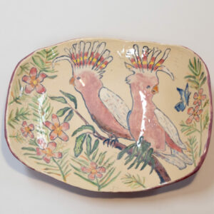 Large ceramic bowl with cockatoos perched on a branch.