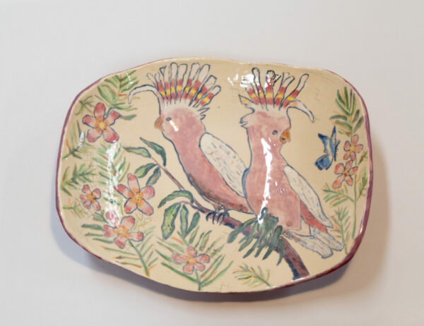 Large ceramic bowl with cockatoos perched on a branch.