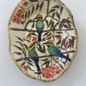 A ceramic bowl showing three rainbow bee-eater birds on a gum tree.