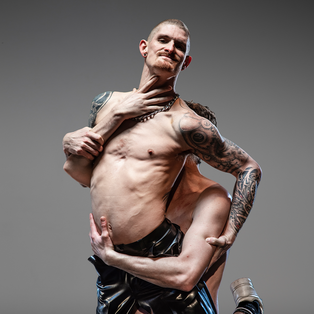 two people are dancing, one is holing the other person up.