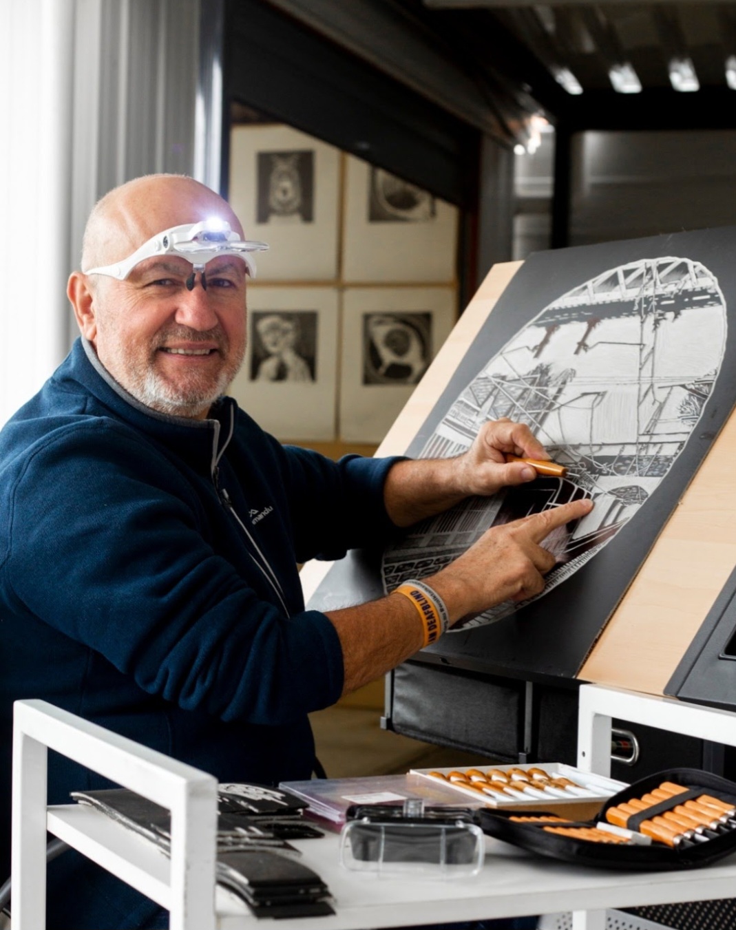 Joe working at home studio on a linocut. photo by Jess Leane.