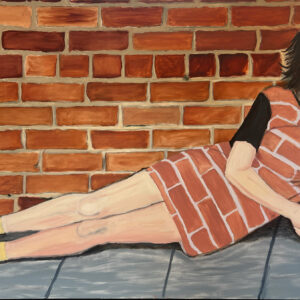 A figure lays in front of a red brick wall looking directly at the camera wearing a dress that also has a red brick pattern on it.