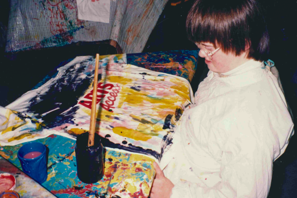 A kid painting t-shirts at Art Party.
