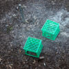 a photo of two green milk bottle cubes from above