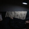 Sarah.Pekin.Photography-6359-20210411.jpg self portrait (me) - a woman laying on a couch staring into a lamp