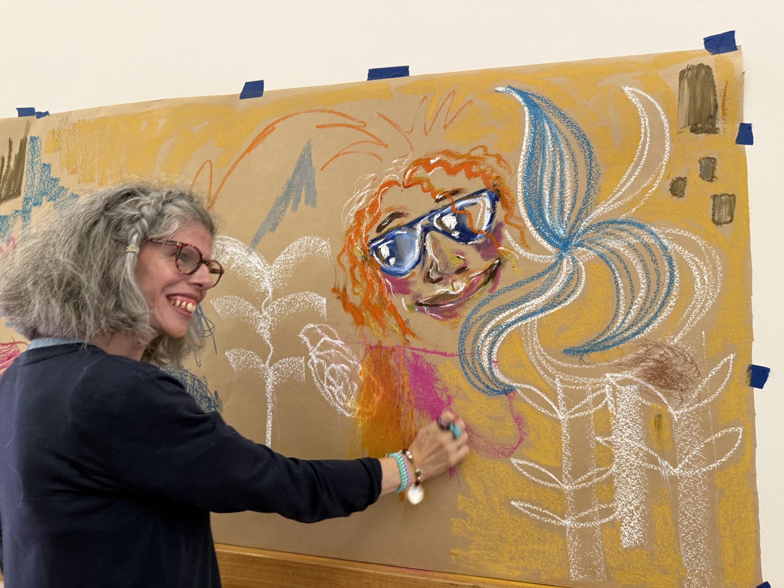 Person drawing on a wall.