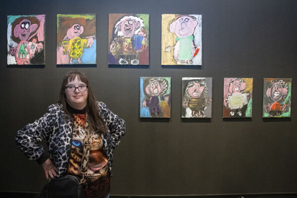 Josephine Lazidis standing in front of her artwork.