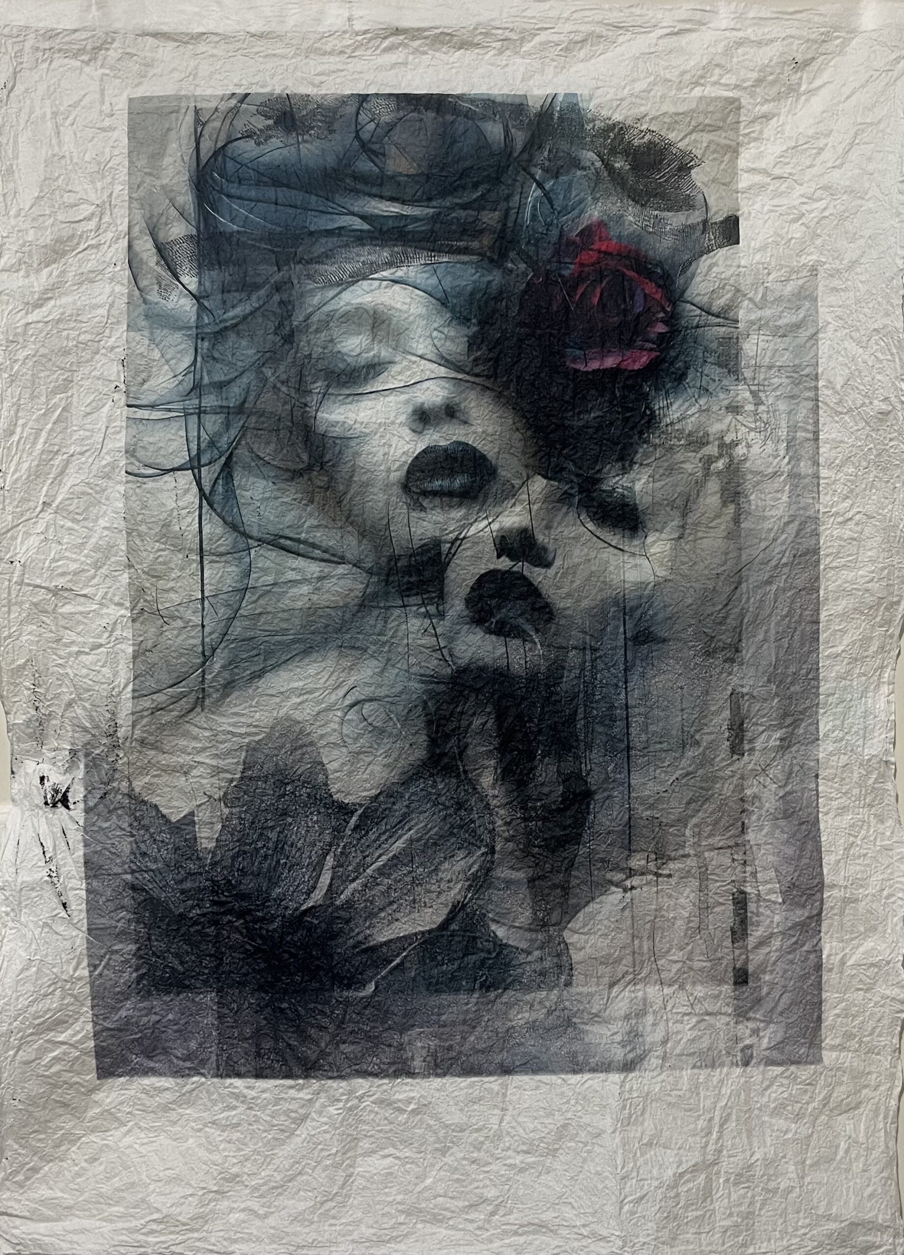 multimedia print of two feminine faces on crinkled paper