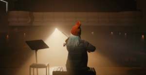 A person playing a violin on stage.