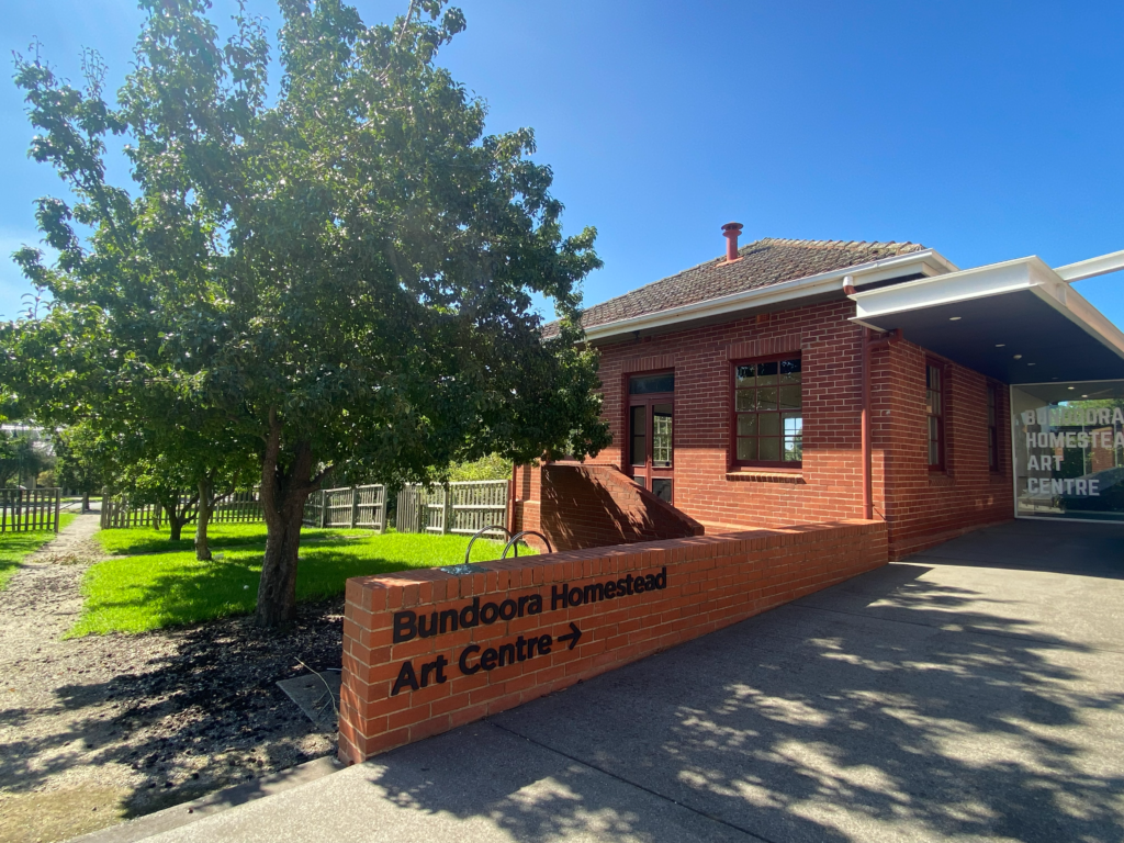Signage pointing to Bundoora Homestead Arts Centre.